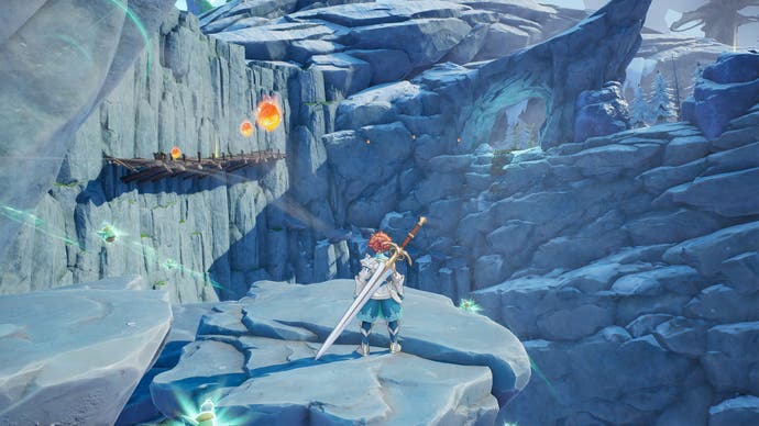 Captura de pantalla del protagonista de Visions of Mana parado en un acantilado rocoso en una zona montañosa
