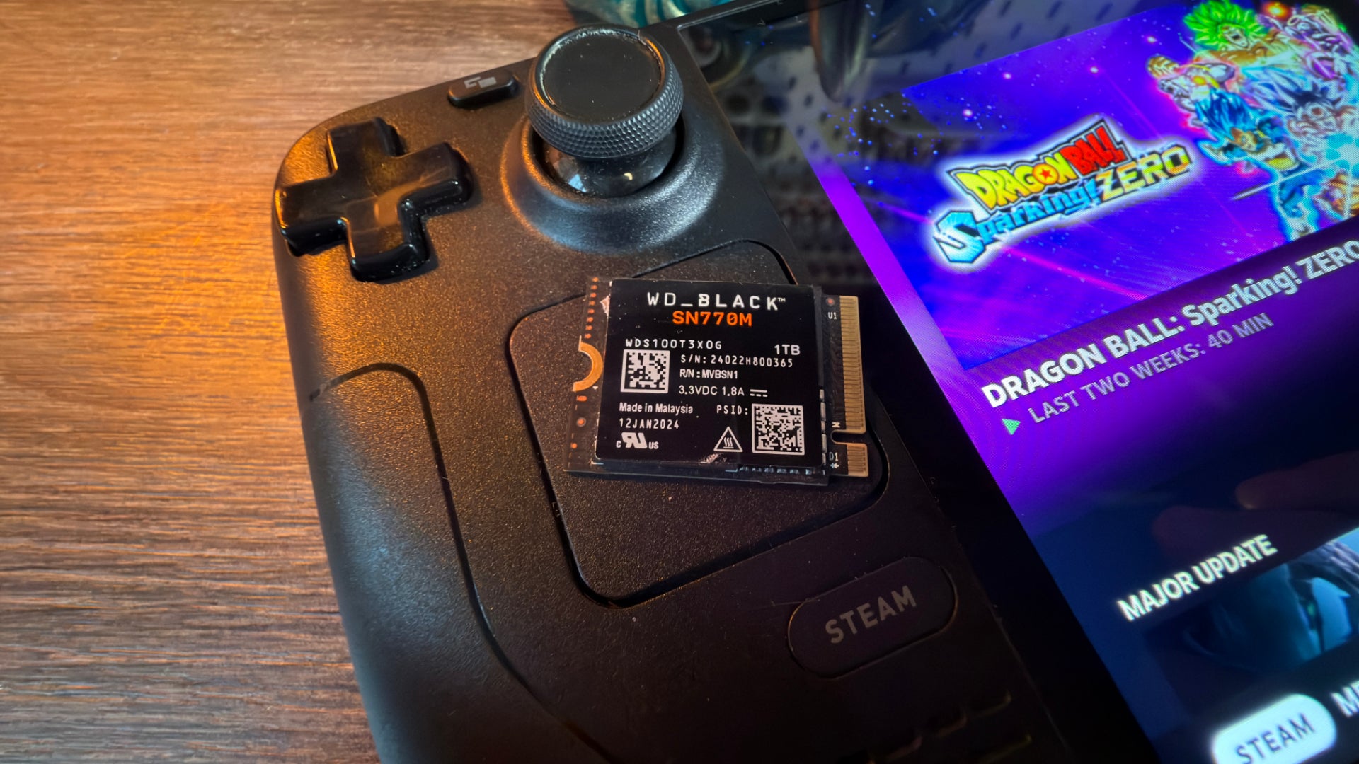 The WD Black SN770M SSD, sat on top of a Steam Deck.