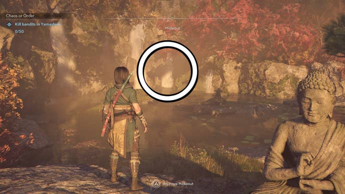 A white circle showing the location of the treasure under a waterfall at the Hideout in Assassin’s Creed Shadows.