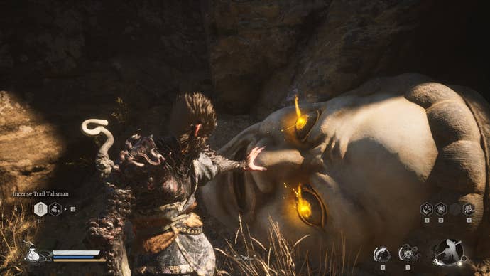 The player approaches a Buddha Head, where they can retrieve the Buddha’s Eyeballs, in Black Myth Wukong