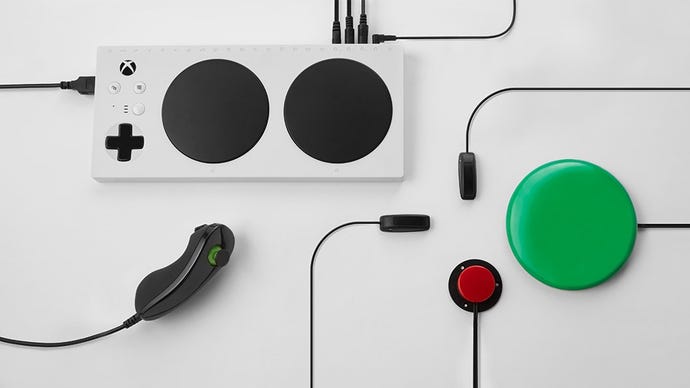 Microsoft's Xbox Adaptive Controller and some accessories on a white table.