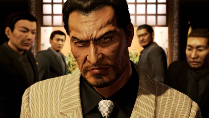 Yakuza 5 Remastered screenshot showing an angry looking man in a suit surrounded by henchmen