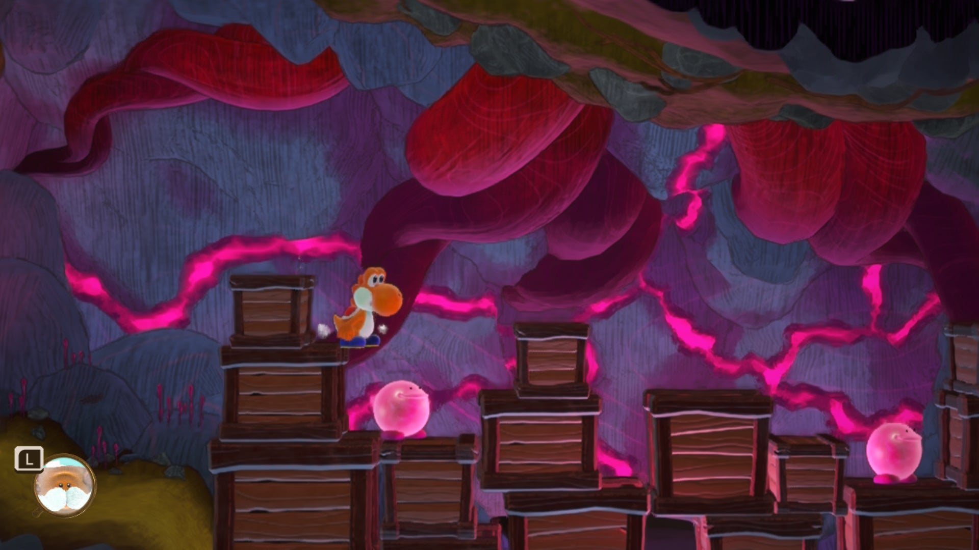 Yoshi and the Mysterious Book screenshot showing traversal over crates against a pink and purple rocky background