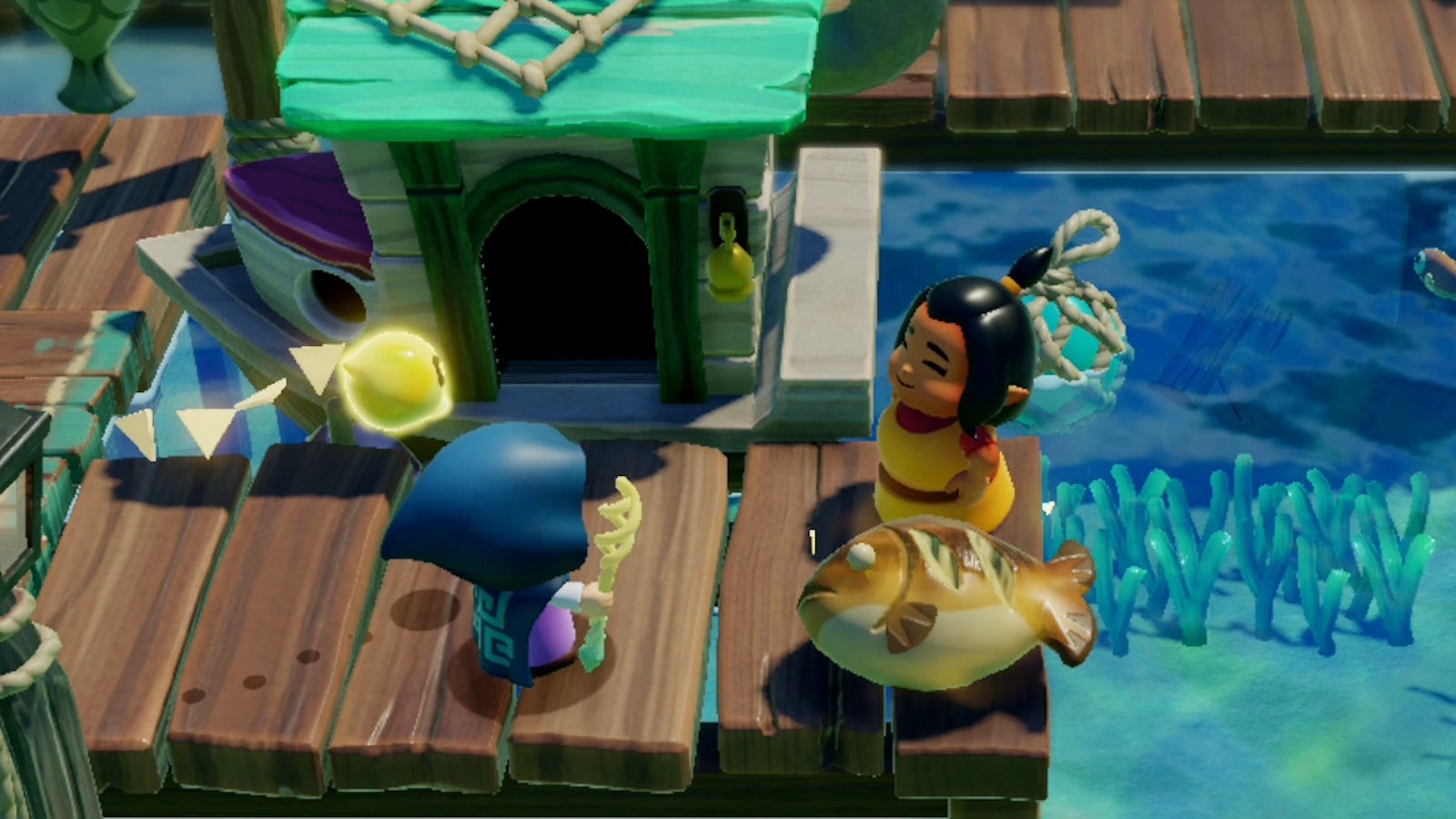 Zelda speaking with Anube&rsquo;s mother on the docks of Seesyde Village, with a fish in between them, in Zelda Echoes of Widsom.