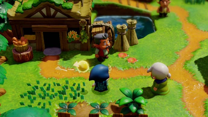 Zelda talking to an elderly couple in a grassy village in Zelda Echoes of Wisdom.