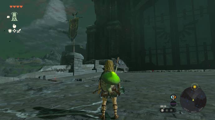 Link looks at crumbling stone walls beside the Hyrule Castle gate in The Legend of Zelda: Tears of the Kingdom