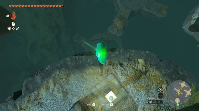 Link holds a crystal over the edge of a small island in Zelda: Tears of the Kingdom