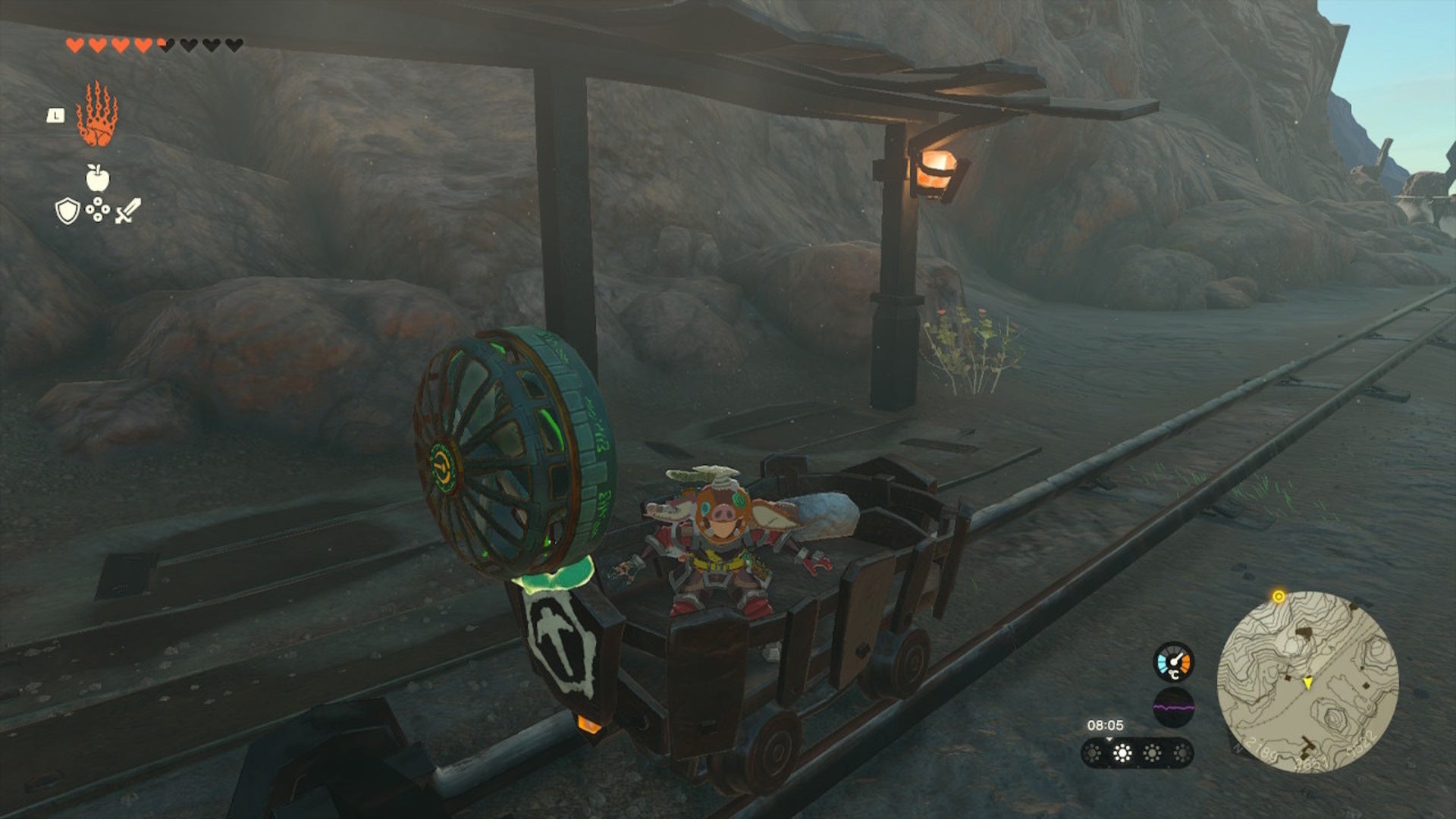 Link hops in a minecart at the base of Death Mountain in The Legend of Zelda: Tears of the Kingdom