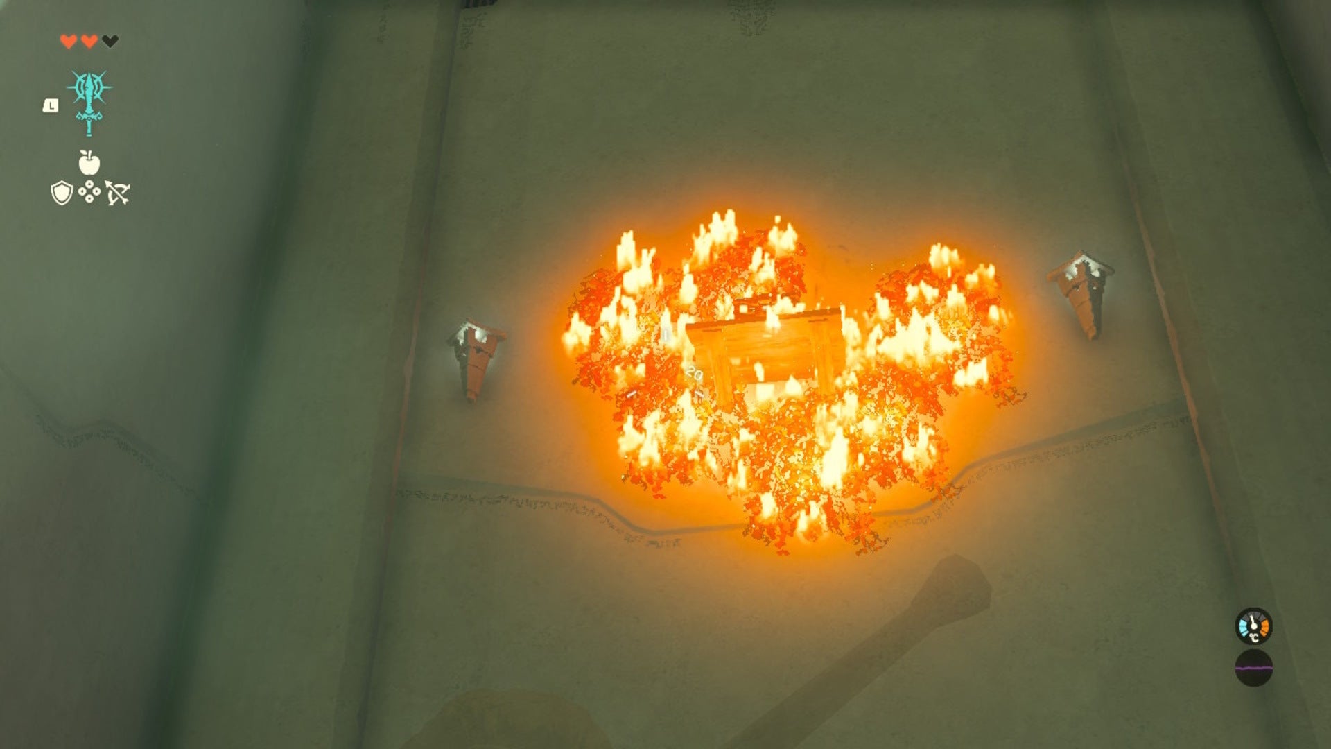 Link looks at some burning branches and a chest after setting them alright with Fire Fruit in the In-Isa Shrine of The Legend of Zelda: Tears of the Kingdom