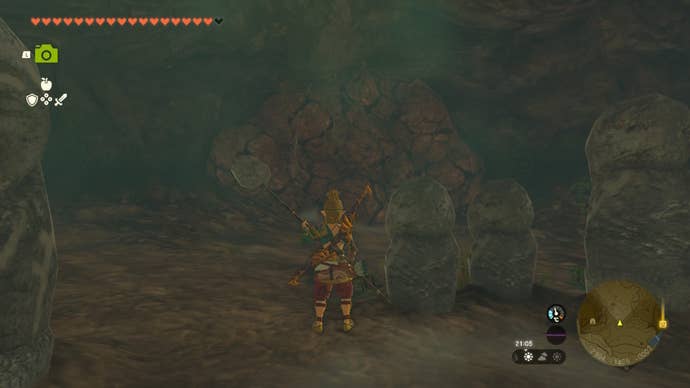 Link stands beside some statue and faces a rock wall in a cave in The Legend of Zelda: Tears of the Kingdom