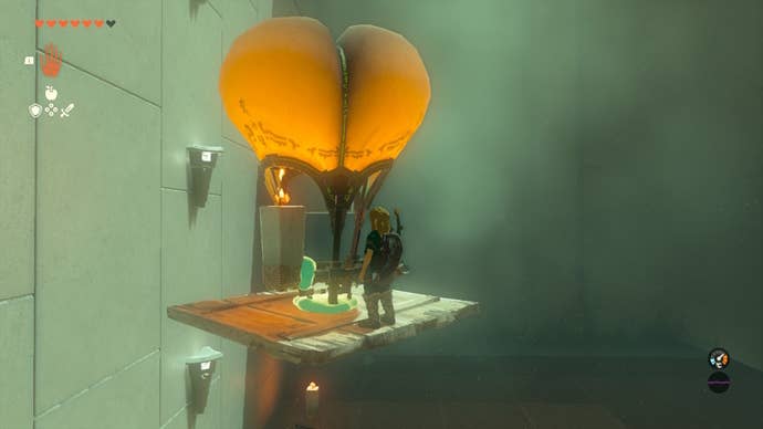 Link flies using a plank and hot air balloon in the Sinakawak Shrine in The Legend of Zelda: Tears of the Kingdom