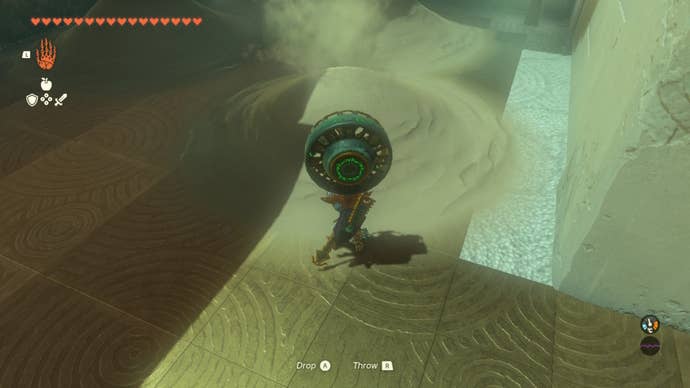 Link uses a fan on a pile of sand in The Legend of Zelda: Tears of the Kingdom