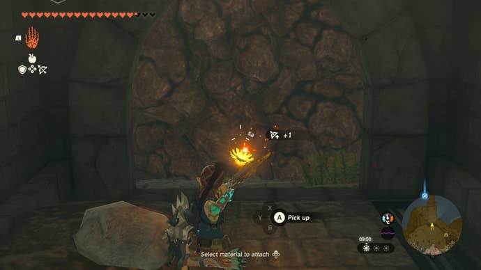 Link aims an arrow and Bomb Fruit at a passage blocked by rocks in The Legend of Zelda: Tears of the Kingdom