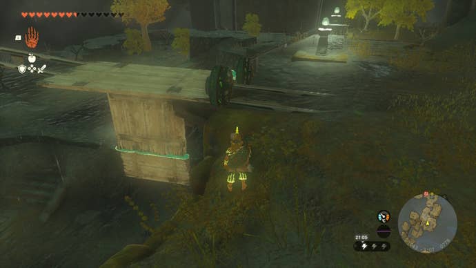 Link looks at a wooden mine cart contraption in The Legend of Zelda: Tears of the Kingdom