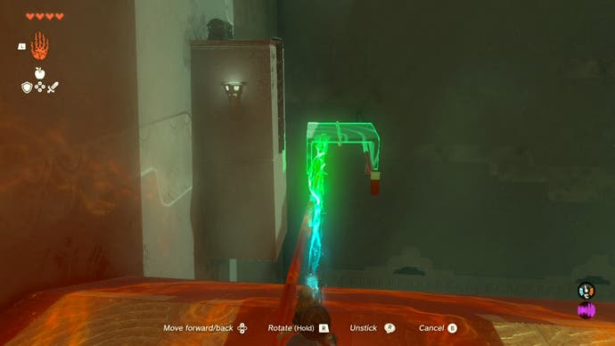 Link using the Ultrahand ability to place a stone platform on a railing in the Runakit Shrine so the player can access a treasure chest.