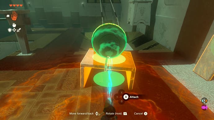 Link using the Ultrahand ability to attach a large metal ball on top of a stone platform the player created in the Runakit Shrine.