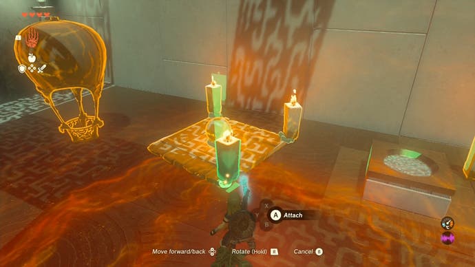Link using the Ultrahand ability to move a small metal ball onto a square piece of wood which has large candles attached to it.