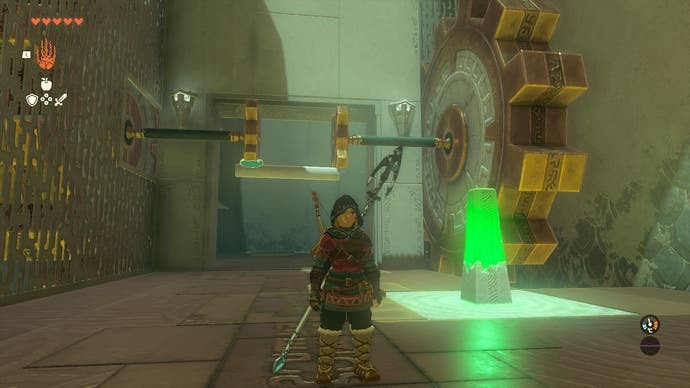 Link standing by a massive gear in the Riogok Shrine that's the size of a wall.