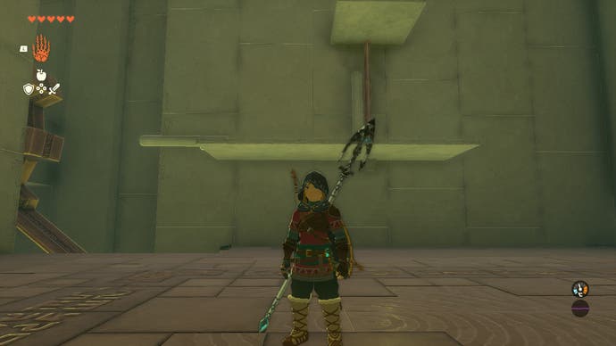 Link standing in a room in the Riogok Shrine which has large platforms joined to the wall.