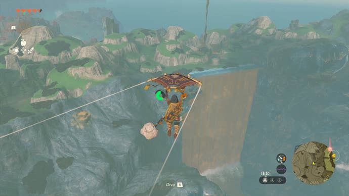 Link gliding through the air and approaching a giant, wide waterfall in Hyrule.