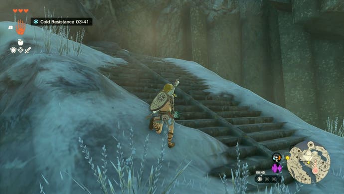 Link standing on a snowy patch of ground by a rocky staircase in The Legend of Zelda: Tears of the Kingdom.