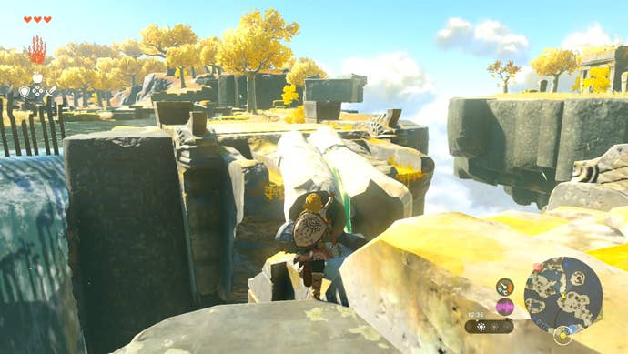 Link creating a makeshift bridge out of wooden logs in The Legend of Zelda: Tears of the Kingdom.