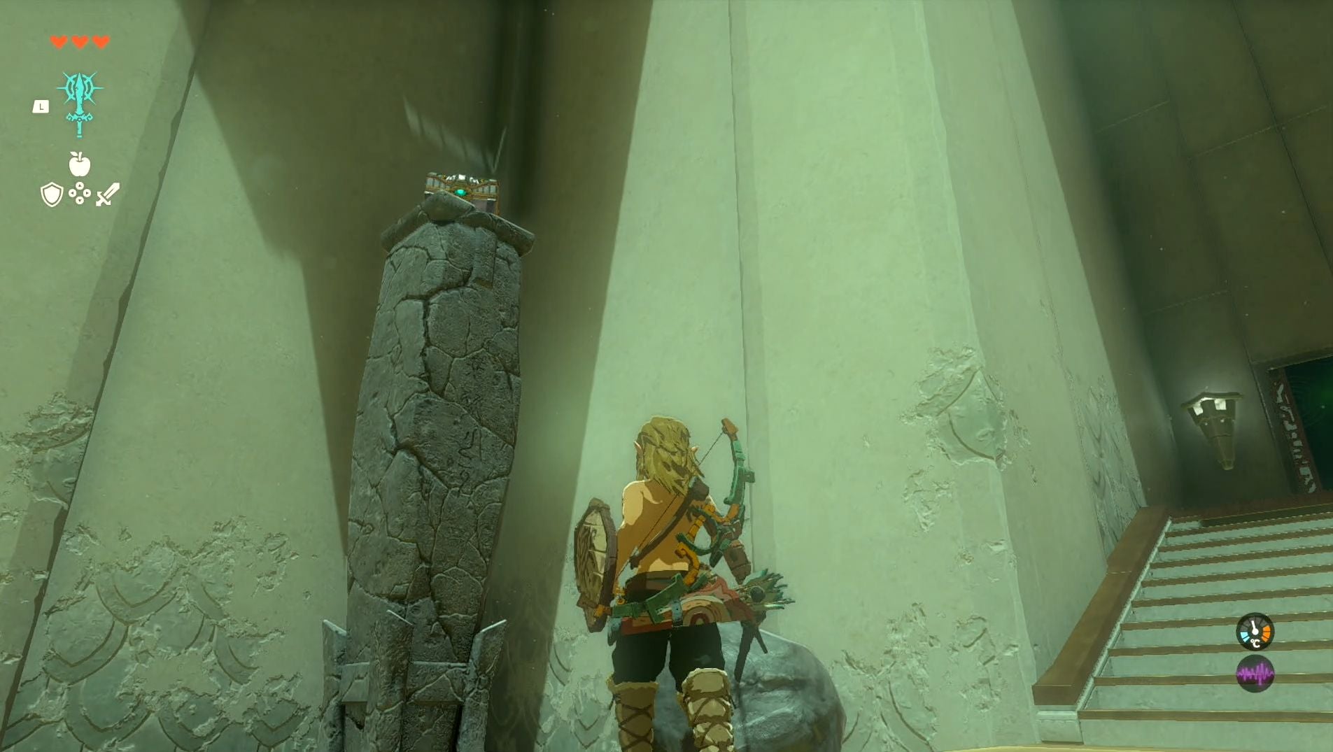 Link standing near a chest atop a pillar in the In-Isa Shrine in The Legend of Zelda: Tears of the Kingdom.