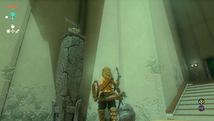 Link standing near a chest atop a pillar in the In-Isa Shrine in The Legend of Zelda: Tears of the Kingdom.