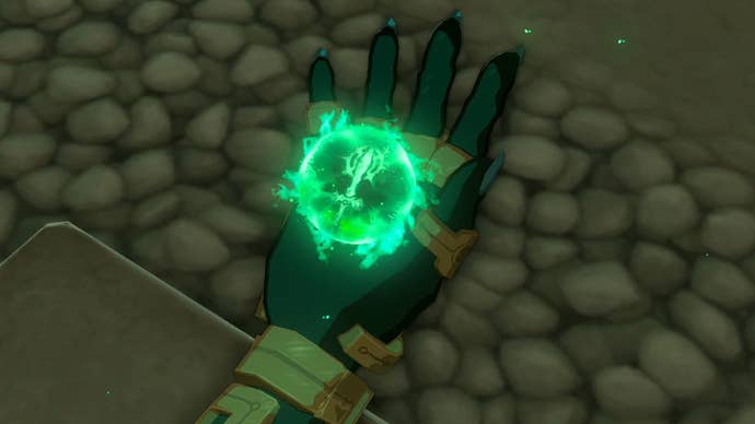A close-up of Link’s hand showing a green, glowing orb floating in his palm in The Legend of Zelda: Tears of the Kingdom.