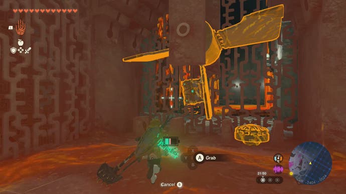 Link approaching a chest that's attached to a fan in the Left-Arm Depot in Tears of the Kingdom.