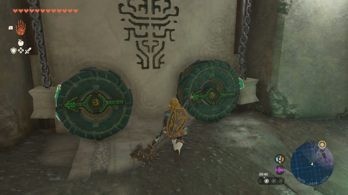 Link attaching wheels to a door to solve a puzzle in the Left-Arm Depot in The Legend of Zelda: Tears of the Kingdom.