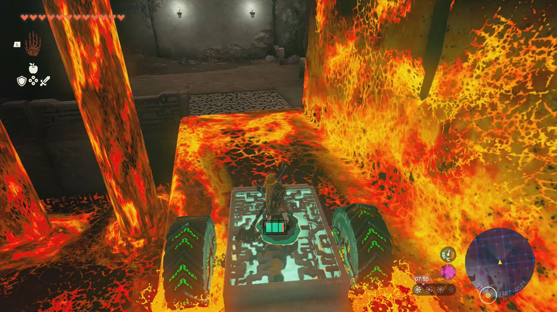 Link using his Ultrahand ability and a makeshift little car to move across lava in the Left-Arm Depot in Zelda: Tears of the Kingdom.