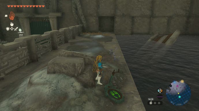 Link standing by a pool of water in the Left-Leg Depot in The Legend of Zelda: Tears of the Kingdom.