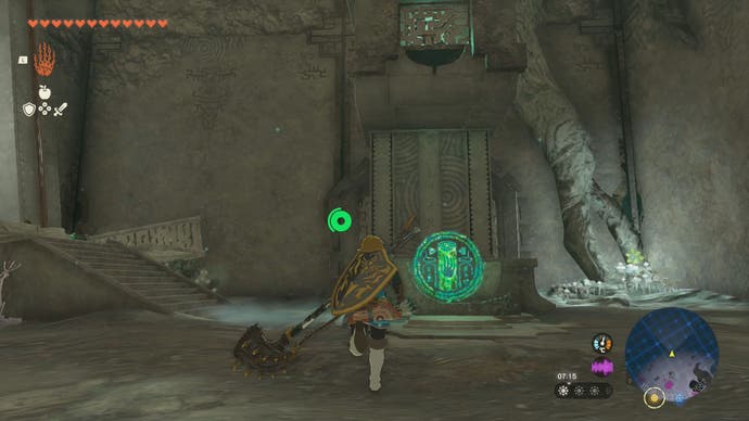 Link approaching a large stone pillar and a green glowing circle which, when interacted with, will give the player the Construct's left-leg.