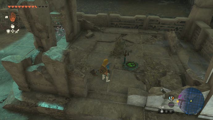 Link standing near a Steering Stick that's located outside the Right-Arm Depot in Tears of the Kingdom.