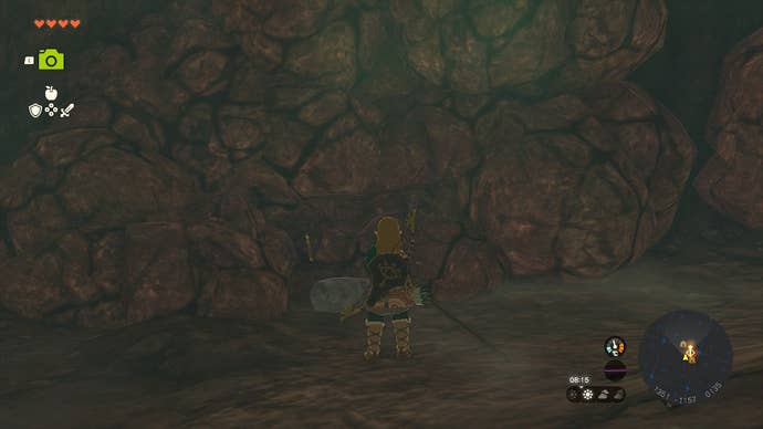 Link standing next to breakable rocks lining the walls of the Sahasra Slope Cave.