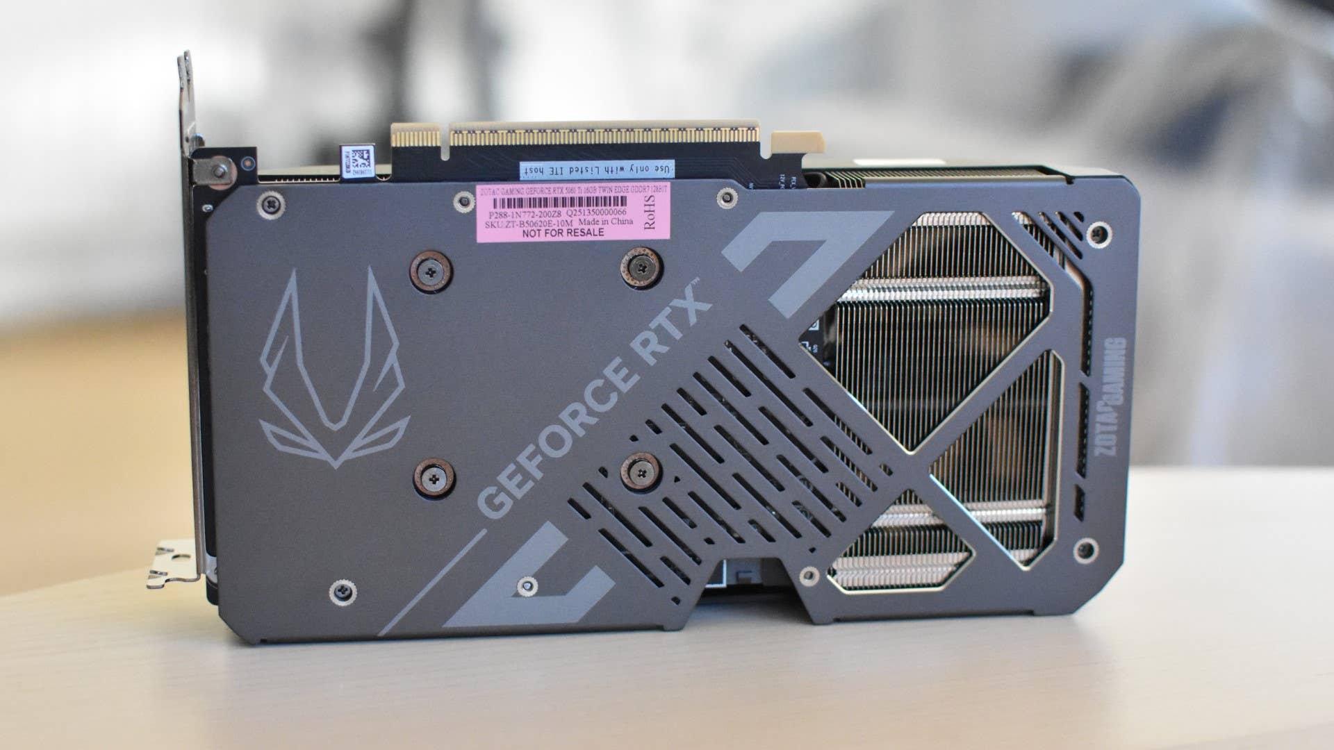 Turn the Zotac Gaming GeForce RTX 5060 Ti Twin Edge on its side, with the backplate facing the camera.