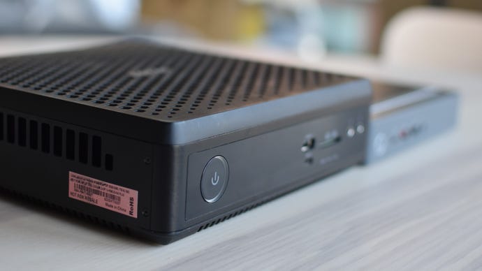 A closeup of a Zotac ZBOX Magnus EN374070C mini PC next to an Acer Revo Box.