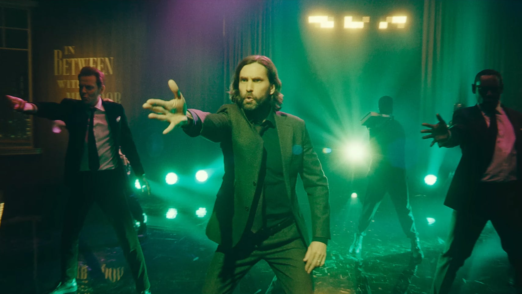 Alan Wake is dancing on a stage alongside Mr Door and Sam Lake in Alan Wake 2. - 1