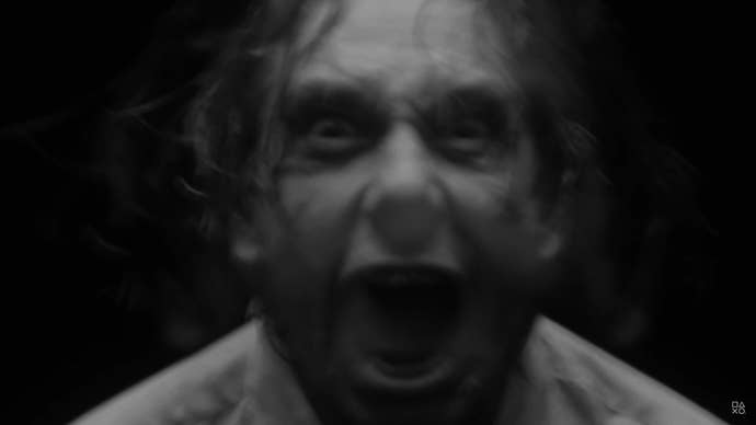 The ghostly image of a screaming man’s face emerges from the shadows.