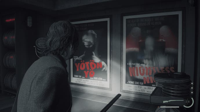 A screenshot from Alan Wake 2 showing Alan looking at two movie posters and holding a rifle