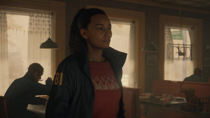 A screenshot of Saga Anderson inside a diner in Alan Wake 2