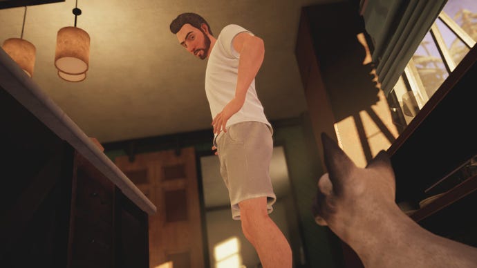 A man looks suspiciously at his cat on the kitchen floor in Alfred Hitchcock - Vertigo