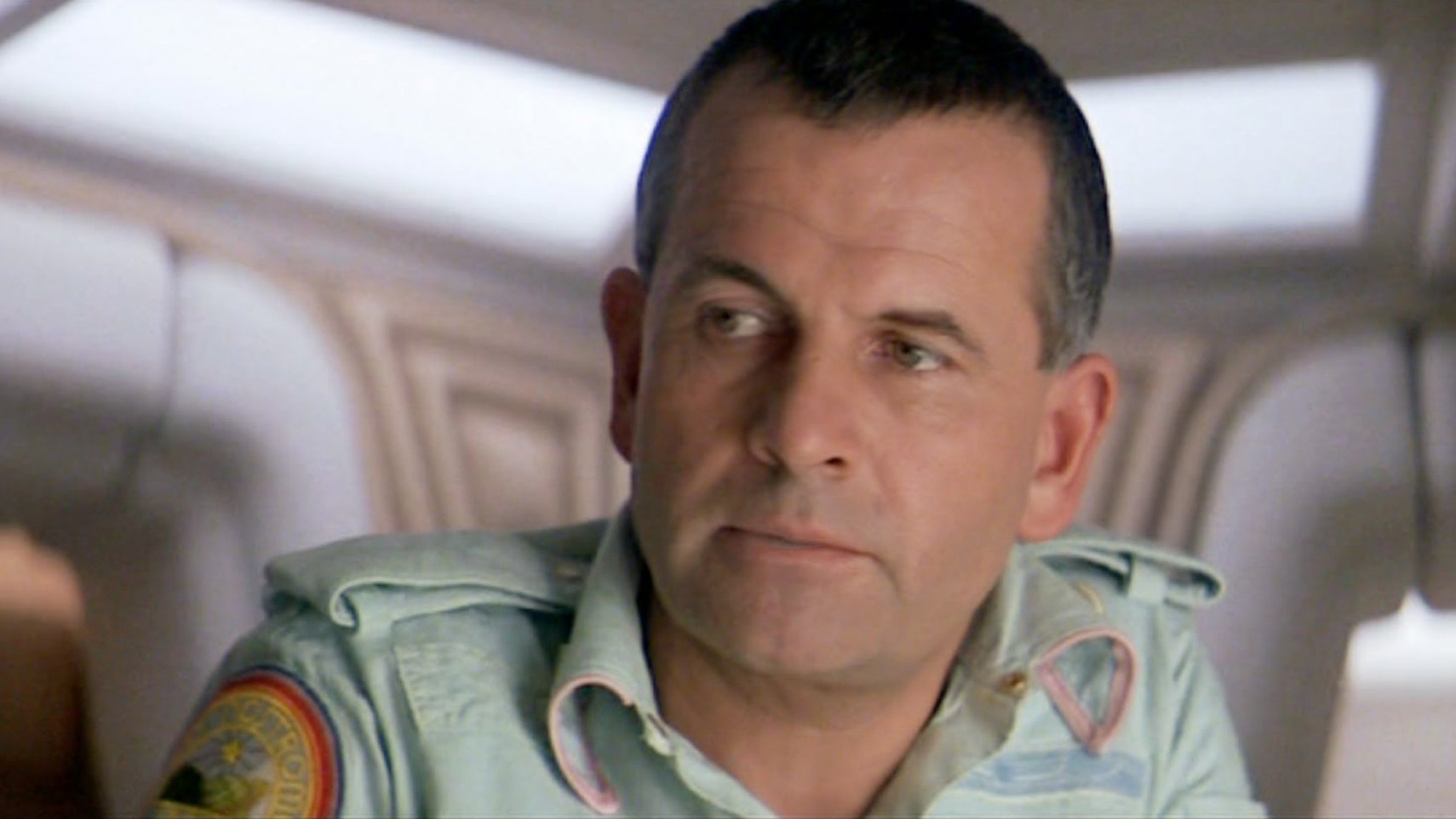 Ian Holm as Ash in the original Alien, he is in a rest area on a spaceship looking at something offscreen. - 1