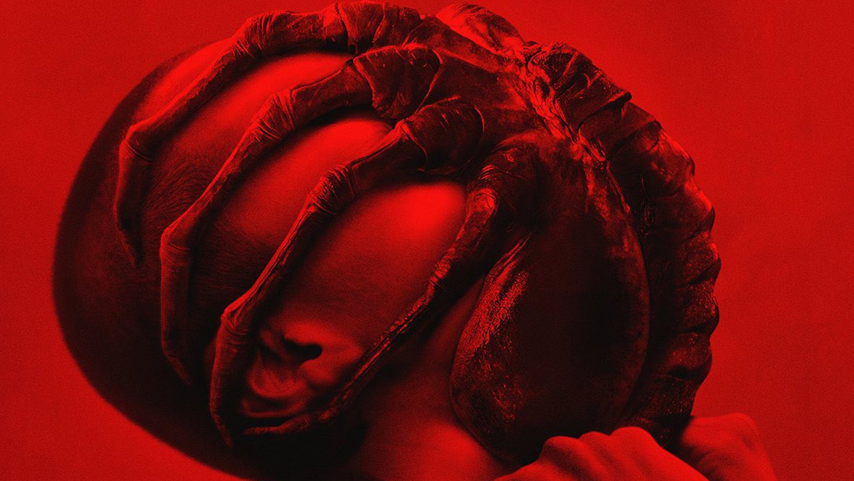 A person with a face hugger from Alien attached to their own face, bathed in a deep red light. - 1
