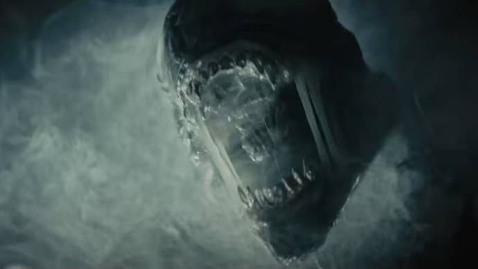 An alien emerges from smoke with its mouth open in the sci-fi horror film Alien Romulus.