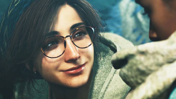 A young woman in glasses called Alma smiling at somebody not quite in shot in Monster Hunter Wilds