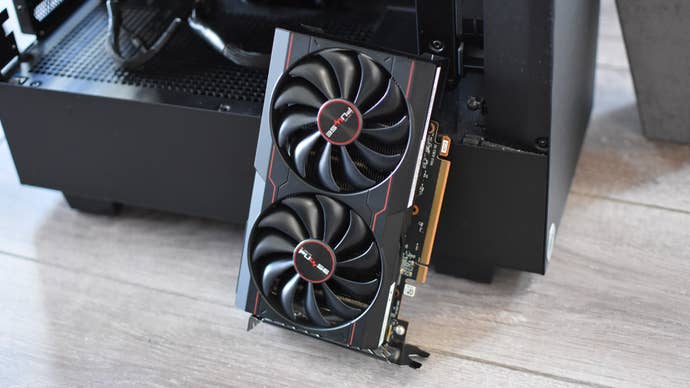 The AMD Radeon RX 6500 XT graphics card propped against an open PC case.
