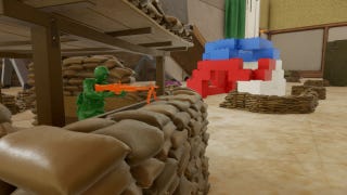 A green toy Army Man aims his machine gun, surrounded by Lego.