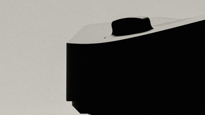 A promotional teaser image for the Analogue 3D showing a close-up of the machine in profile, heavily obscured by shadow.